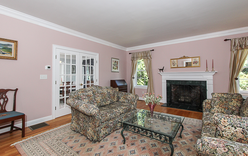 Living room with fireplace and French doors 54 Essex Street Hamilton Massachusetts
