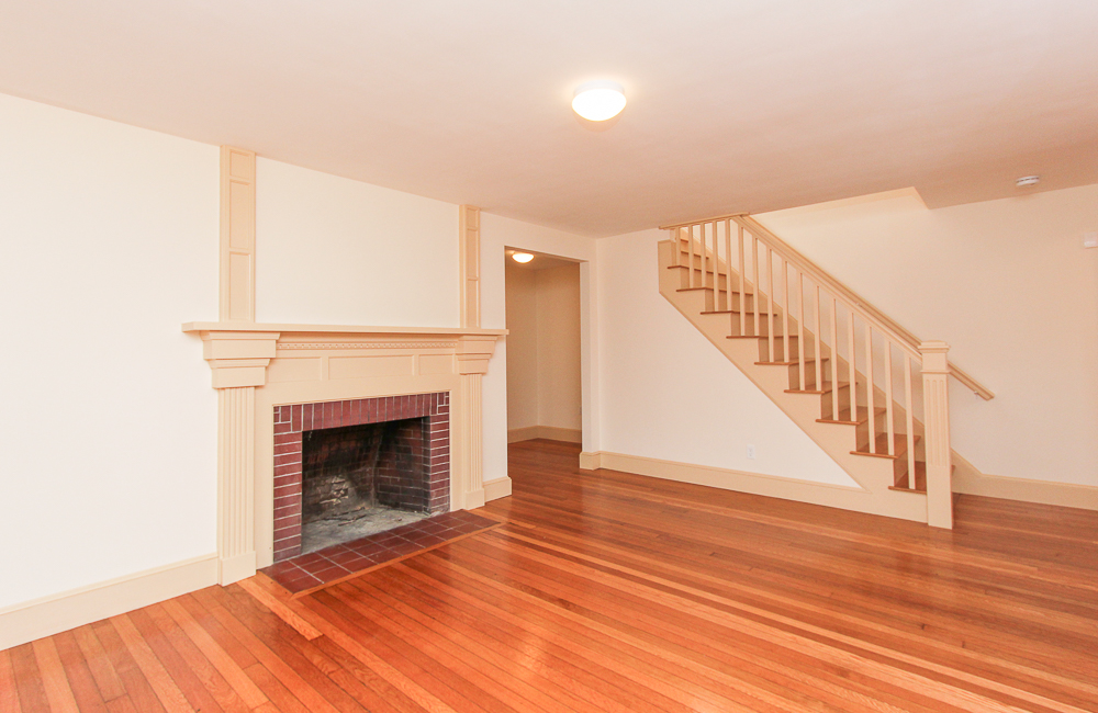 Living room with fireplace and stairway 80 Union Street Hamilton Massachusetts