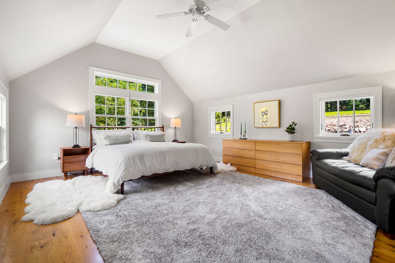 Primary bedroom high ceilings and wood floors 235 Larch Row Wenham MA