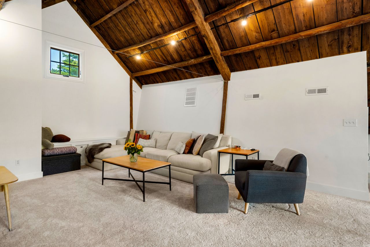 Loft with seating, exposed beams and vaulted ceilings 235 Larch Row Wenham MA